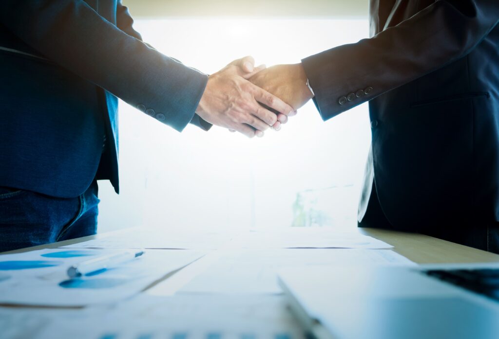 businessmen shaking hands meeting[1]